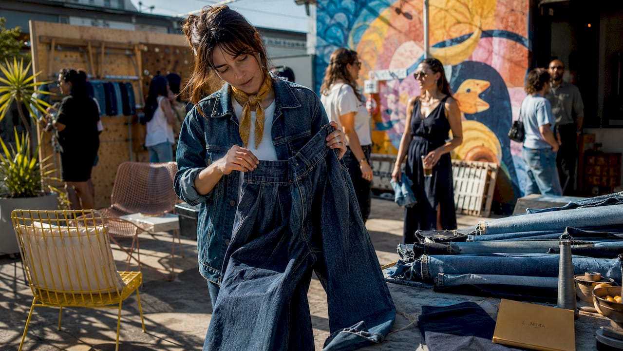 Denim artisan inspecting jeans in LA workshop