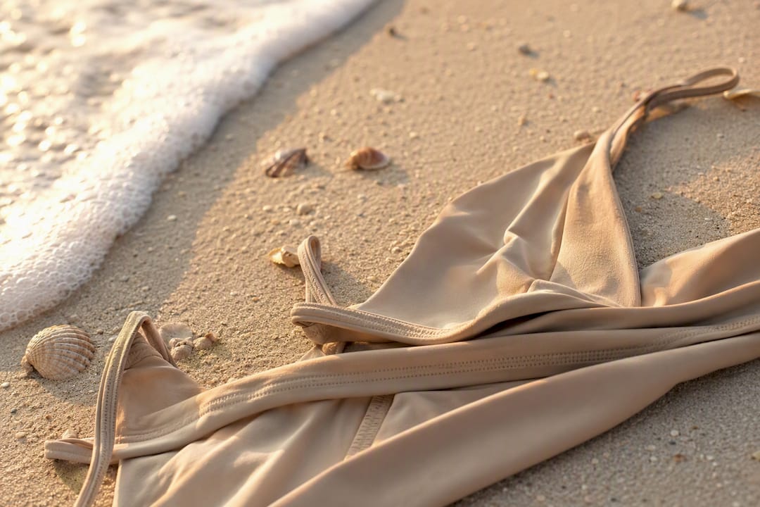 Close-up of minimalist swimwear fabric and gold accents