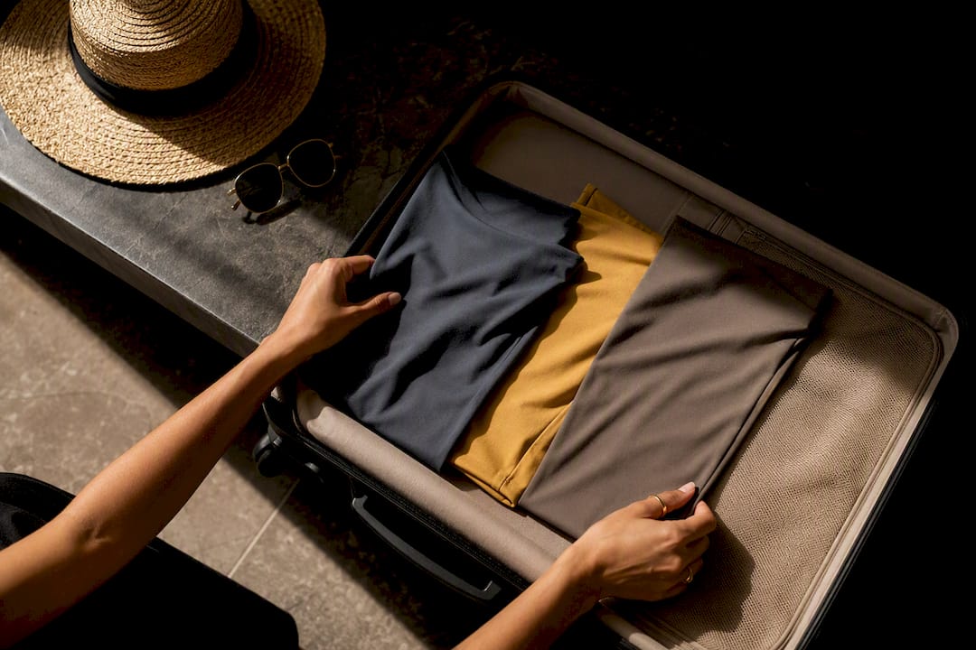 Three swim fabrics arranged in a suitcase